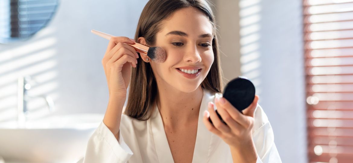 Daily,Makeup.,Smiling,Young,Female,Applying,Blush,With,Makeup,Brush